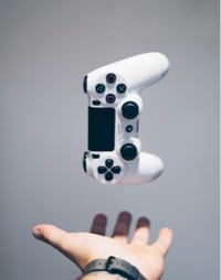 white Sony PS4 DualShock controller over person's palm photo